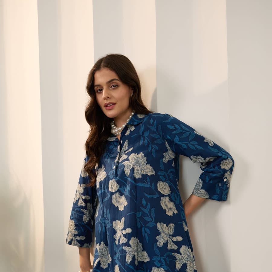 Woman in a blue floral print tunic and pants
