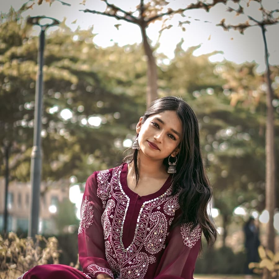 Woman in a relaxed kurta sitting in a park