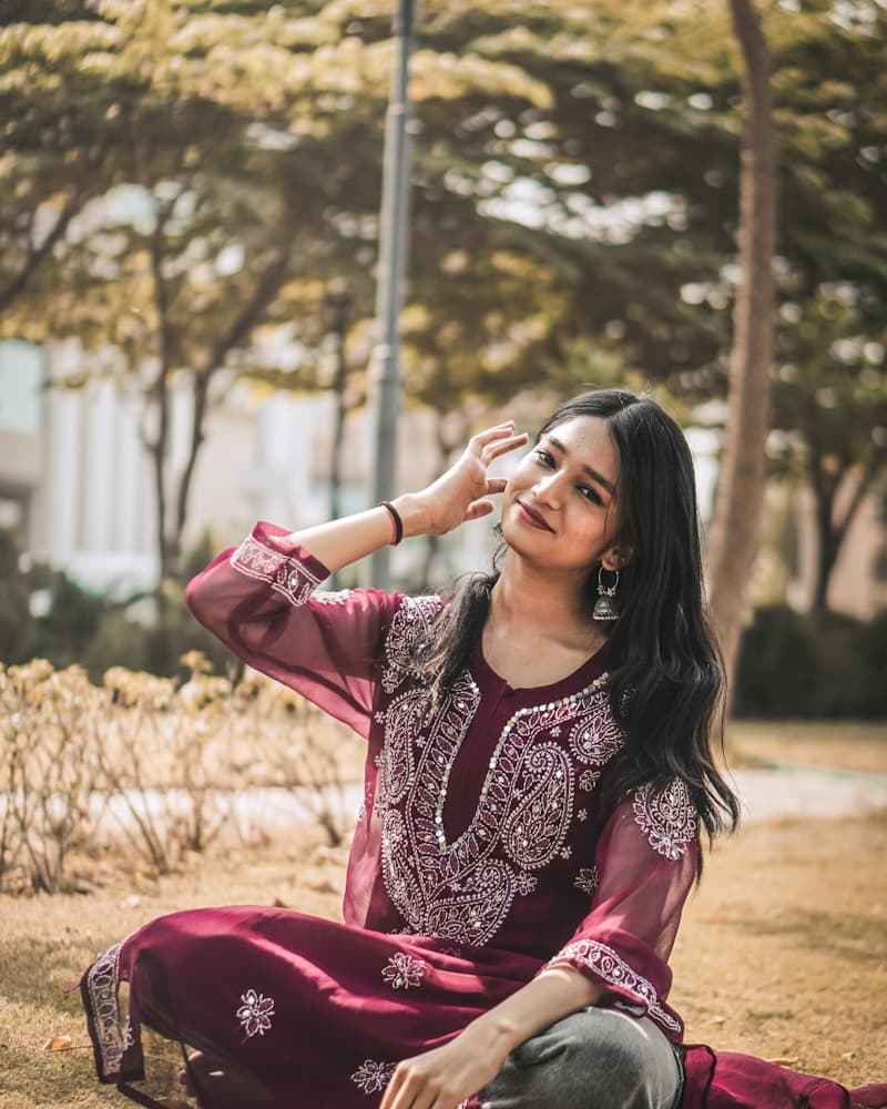 Woman in deep ruby and gold Banarasi bridal wear, detail crop