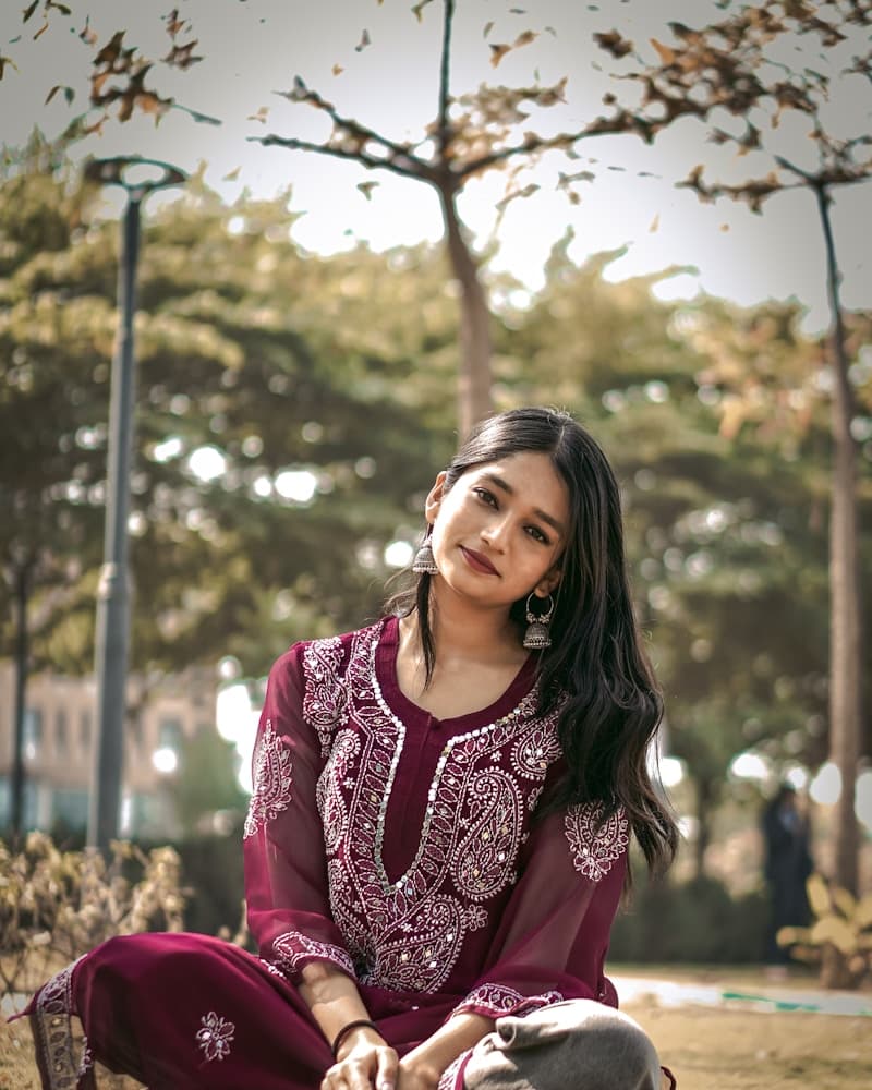 Woman in deep ruby and gold Banarasi bridal wear, full drape