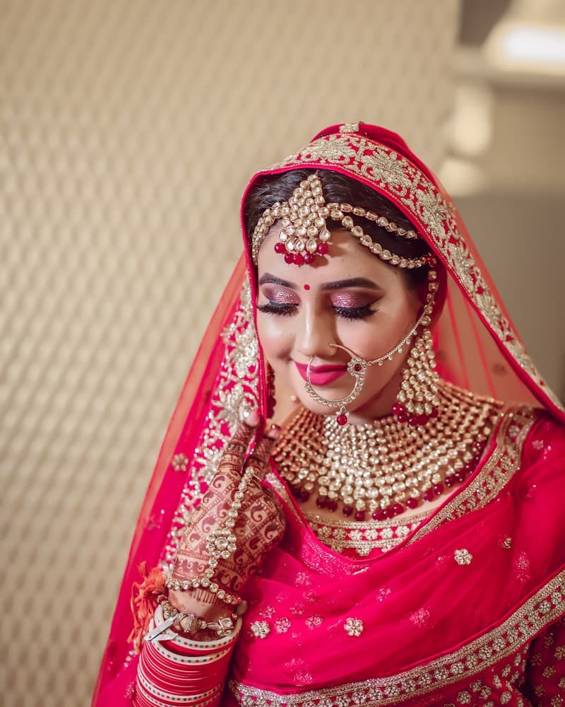 Woman in an ivory Chanderi suit set, smiling, detail crop